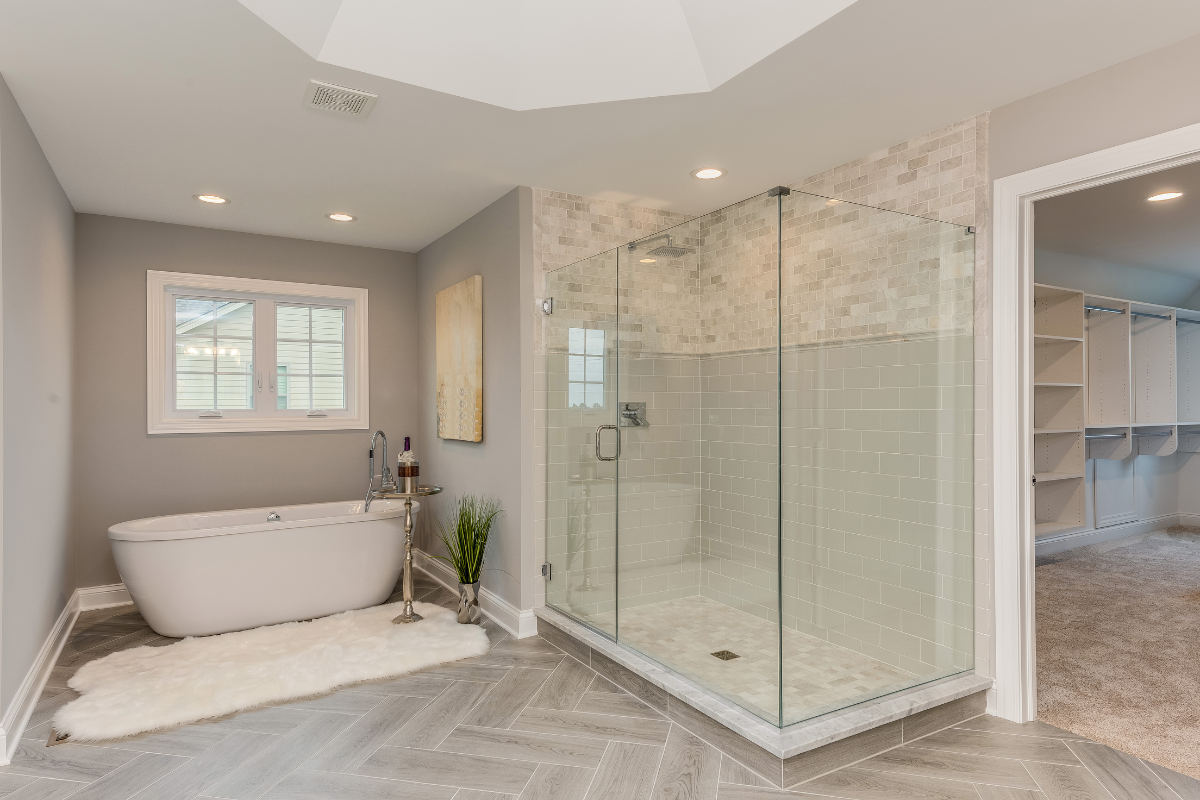 Modern minimalist bathroom design in Toronto with freestanding tub and sleek fixtures