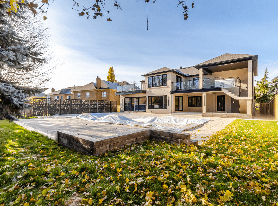 Completed rear home addition with stucco exterior, large windows, and seamless integration in Richmond Hill renovation project by Ridgestone Homes