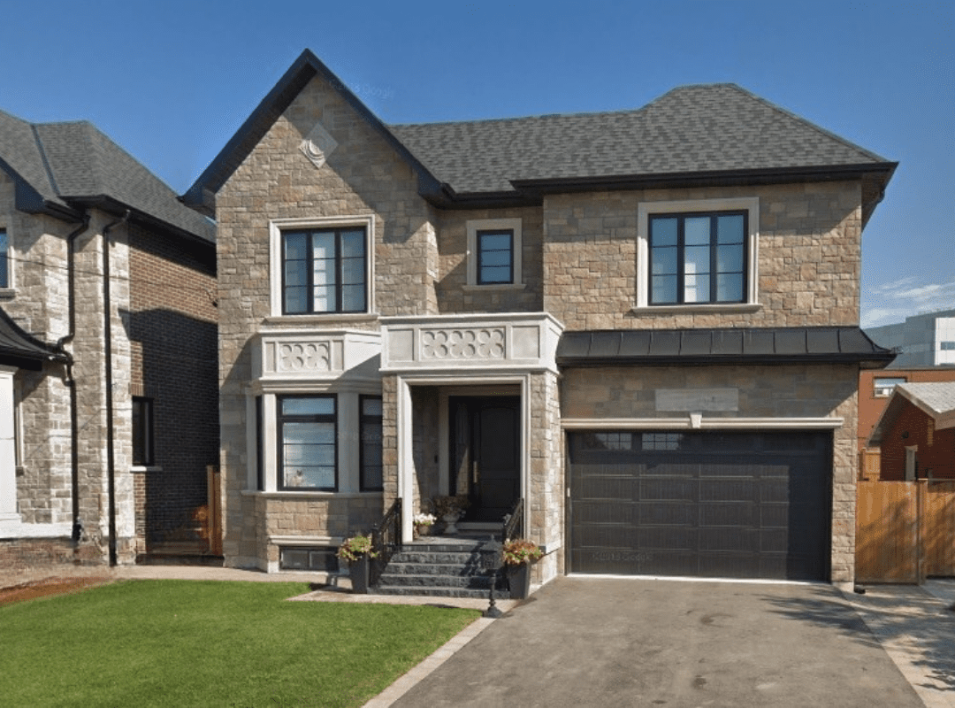 Modern custom kitchen with white shaker cabinets, quartz island, and integrated appliances in Yorkdale–Glen Park design-build home
