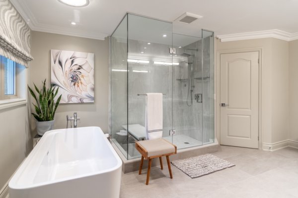 Modern ensuite with double vanity, freestanding tub, and glass shower after renovation in Islington Woods, Vaughan.