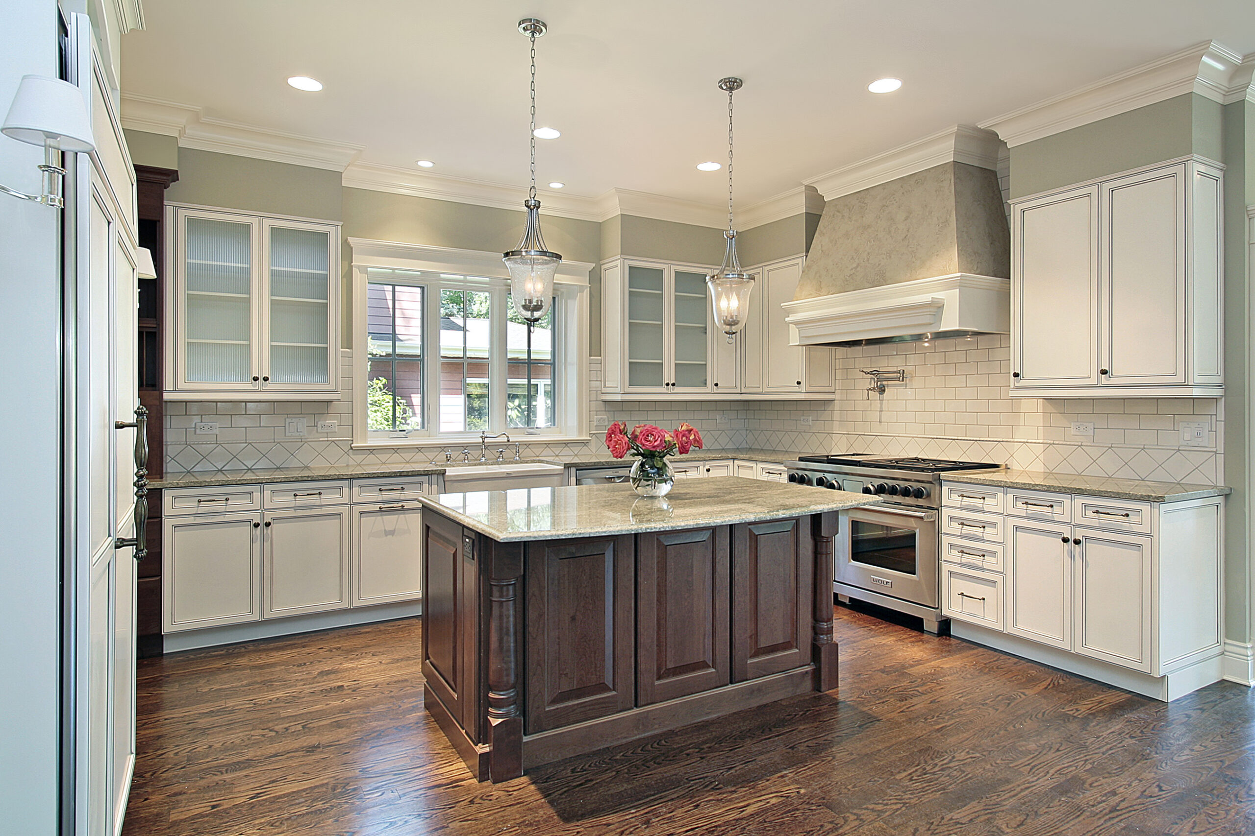 Before and after image of a kitchen renovation with new countertops, cabinets, appliances, and flooring.